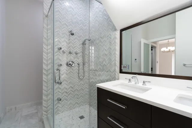 a bathroom with a shower sink and mirror