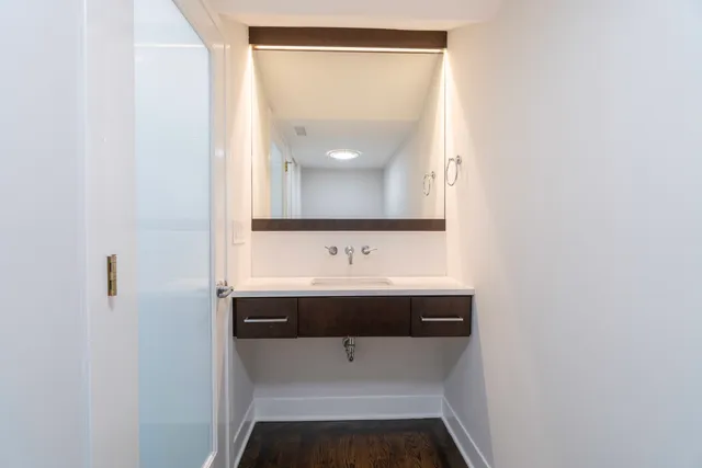 a bathroom with a sink and mirror