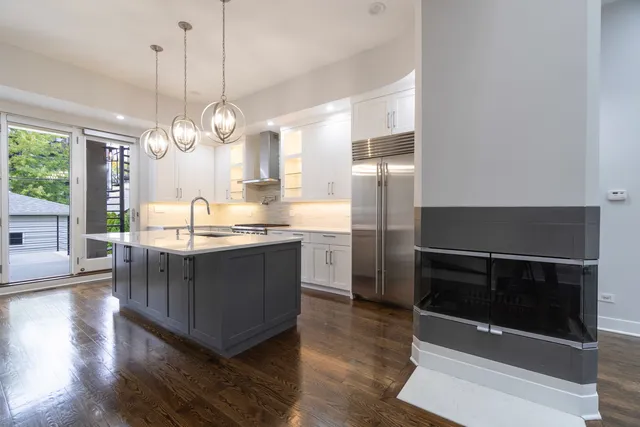 a kitchen with stainless steel appliances granite countertop a stove a microwave and a refrigerator