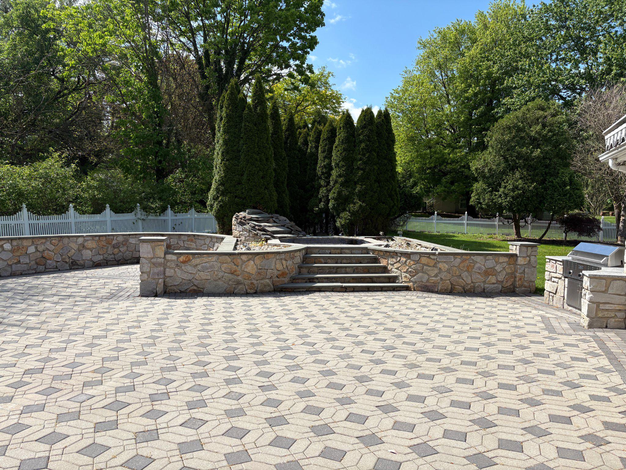 1021 Meetinghouse Road Ambler, PA 19002 - Photo 10 of 41 Serene patio with lush greenery backdrop.