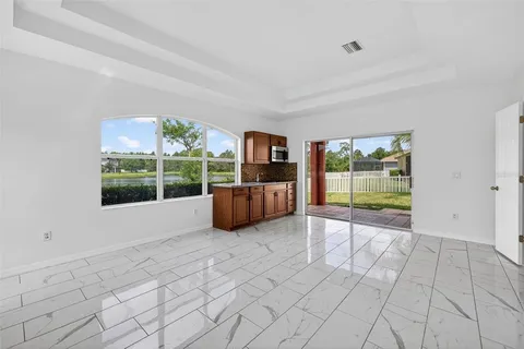 a view of a kitchen with furniture and windows