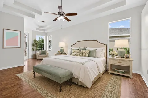 a bedroom with a large bed and a chandelier