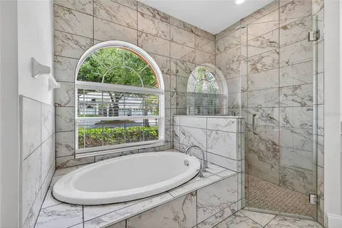 a bathroom with a sink a bathtub and window