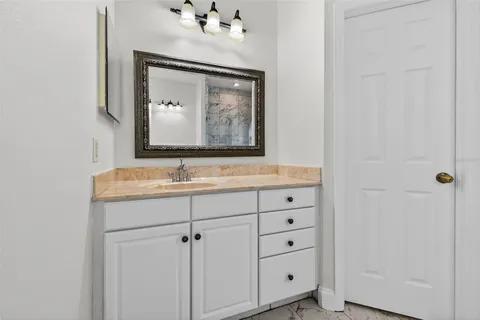 a bathroom with a sink vanity and mirror