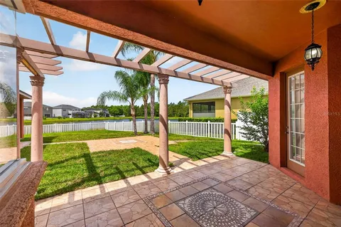 a view of a house with a yard and sitting area