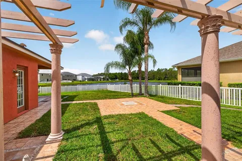 a view of a house with a yard and a patio
