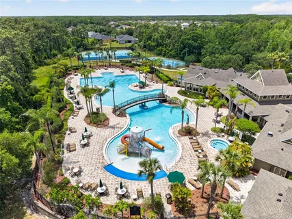 an aerial view of residential houses with outdoor space and swimming pool