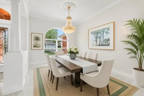 a dining room with furniture a window and a chandelier