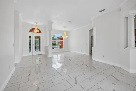 a view of empty room with wooden floor and window