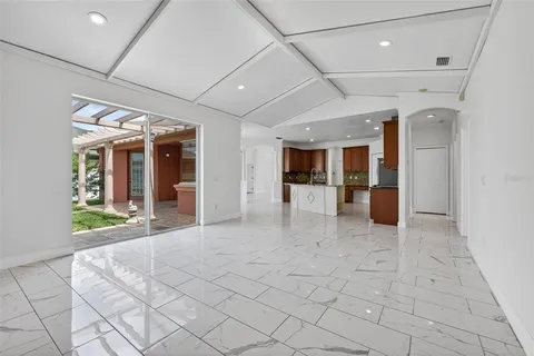 a view of hallway with furniture and a large window