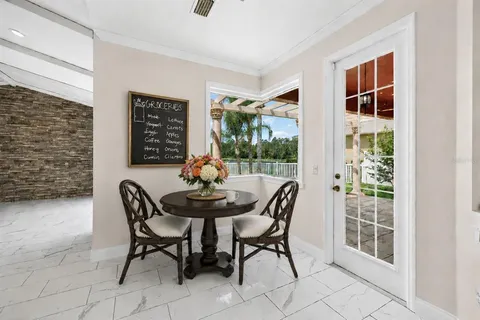 a view of a dining room with furniture and chandelier