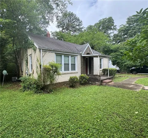 a front view of house with yard and green space
