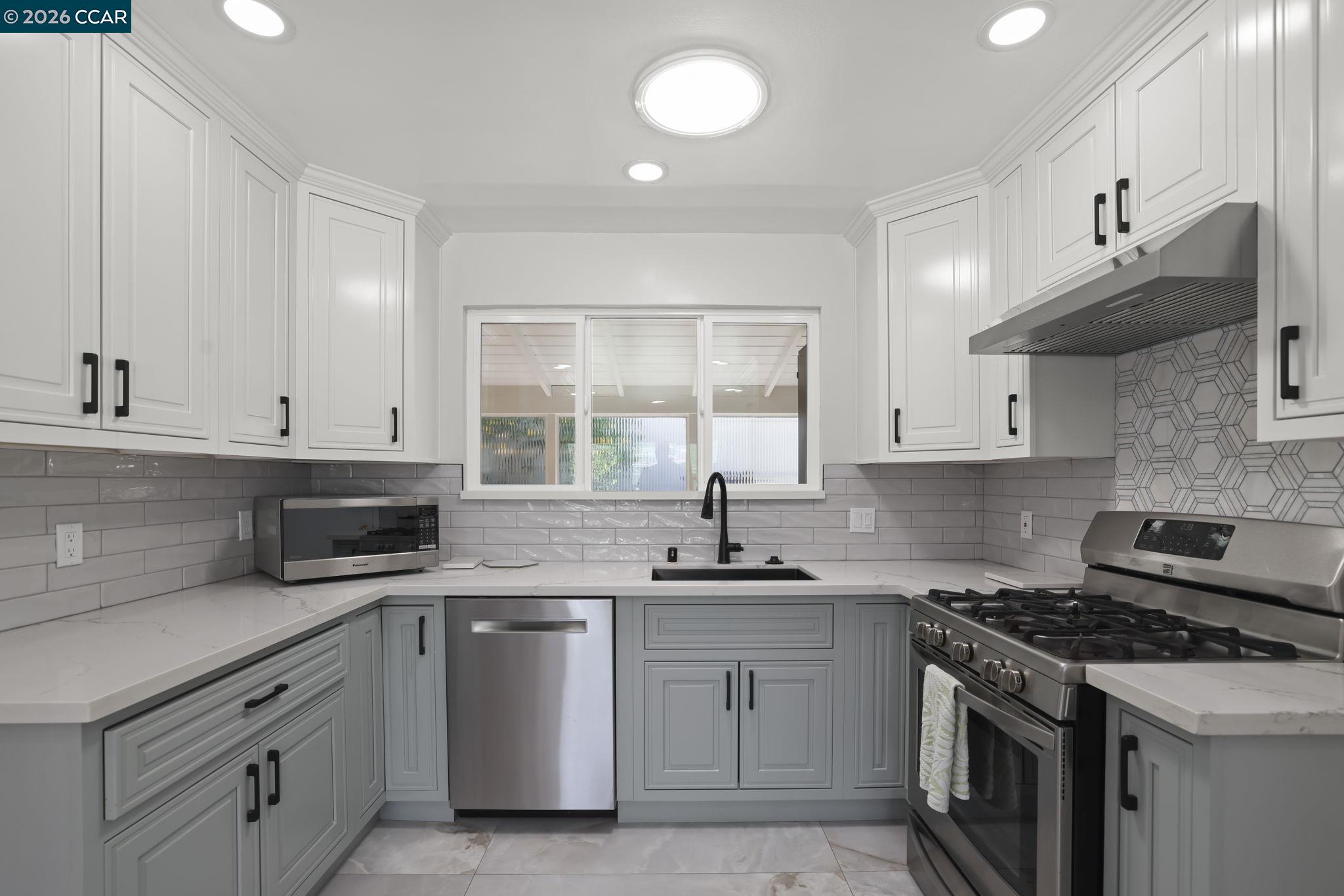 1051 San Rafael Street San Leandro, CA 94577 - Photo 13 of 26 a kitchen with stainless steel appliances a sink stove and cabinets