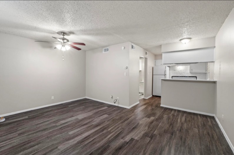 4510 Duval Street, Unit 102 Austin, TX 78751 - Photo 2 of 4 an empty room with wooden floor and ceiling fan