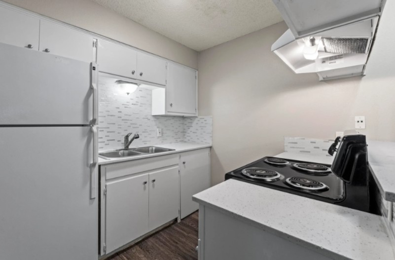 4510 Duval Street, Unit 102 Austin, TX 78751 - Photo 3 of 4 a kitchen with a sink a stove and refrigerator