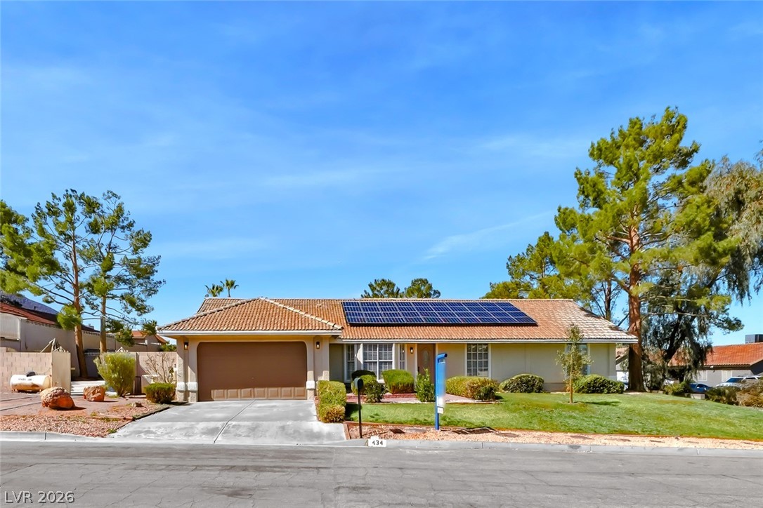 434 Crestway Road Henderson, NV 89015 - Photo 3 of 46 Single story home featuring roof mounted solar panels, a front yard, an attached garage, and stucco siding