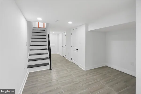 a view of a hallway with stairs and a window