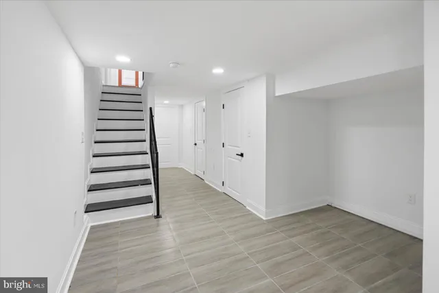 a view of a hallway with stairs and a window