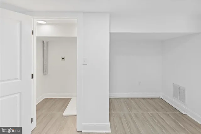 a view of walk in closet with wooden floor