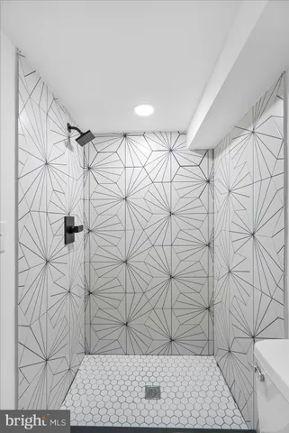 a view of room with wooden floor and white walls