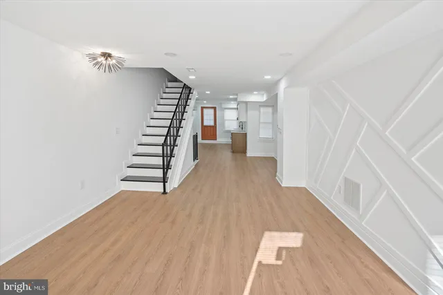 a view of entryway with stairs and wooden floor