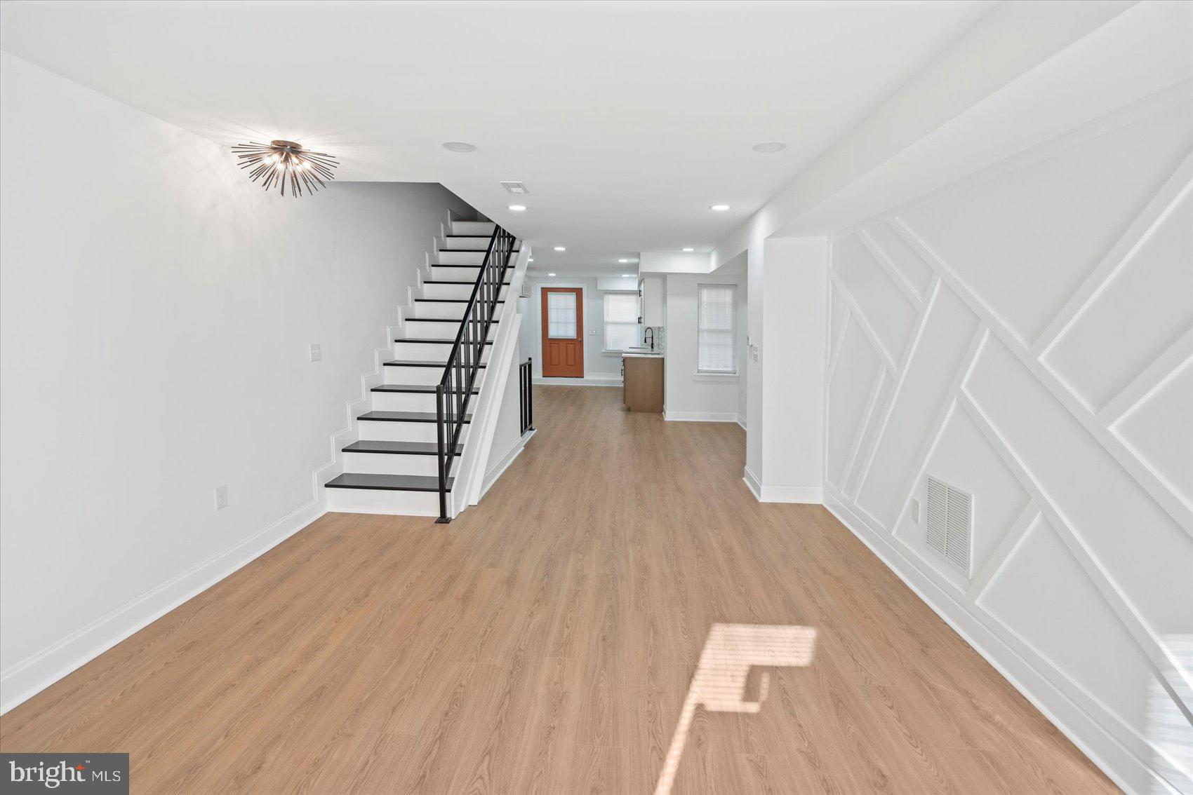 2436 East Biddle Street Baltimore, MD 21213 - Photo 2 of 33 a view of entryway with stairs and wooden floor