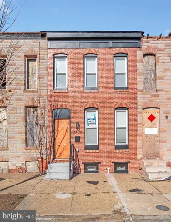 a view of a house with wooden fence