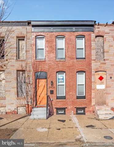 a view of a house with wooden fence