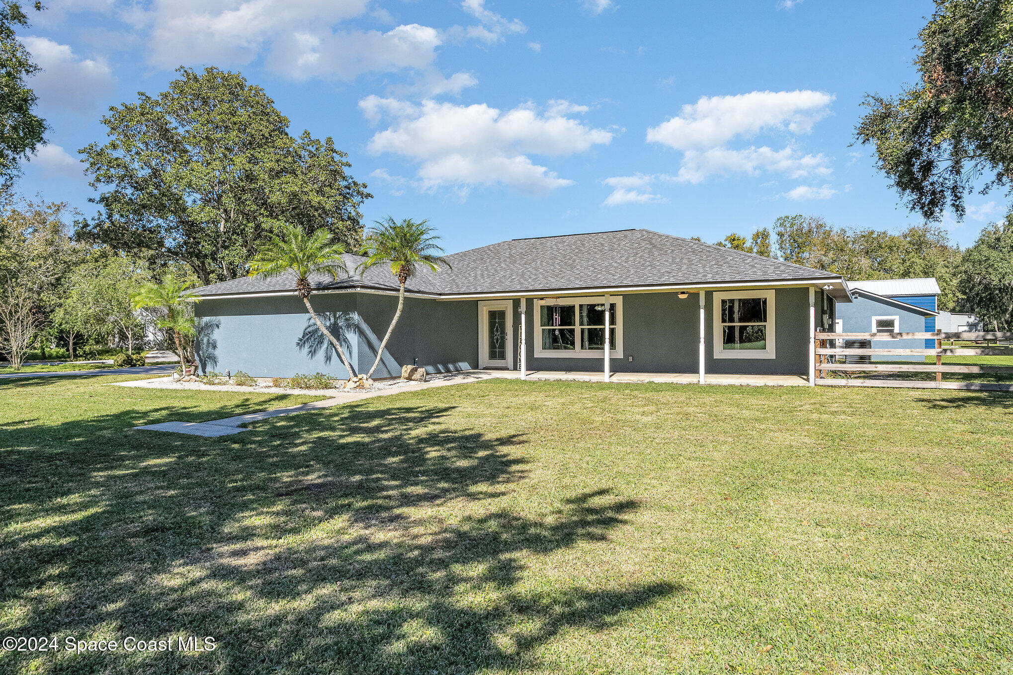 3330 Lionel Road Mims, FL 32754 - Photo 1 of 35 a view of a white house with a swimming pool