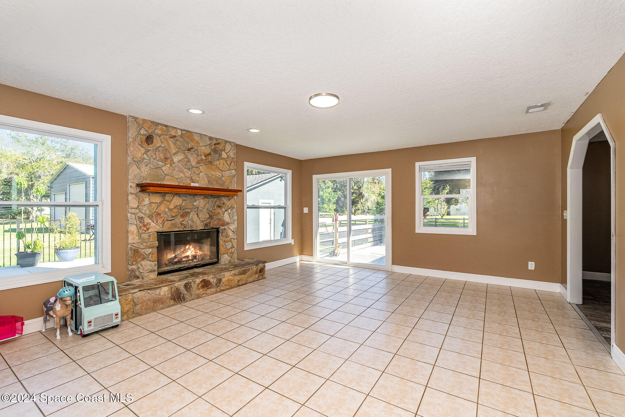 3330 Lionel Road Mims, FL 32754 - Photo 15 of 35 a living room with furniture and a fireplace