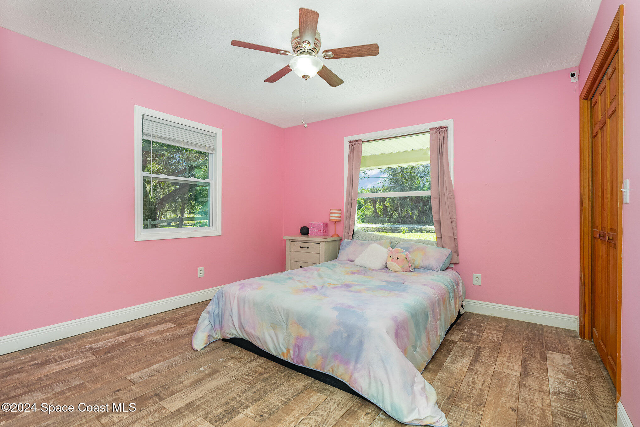 3330 Lionel Road Mims, FL 32754 - Photo 18 of 35 a bedroom with a bed dresser and a window