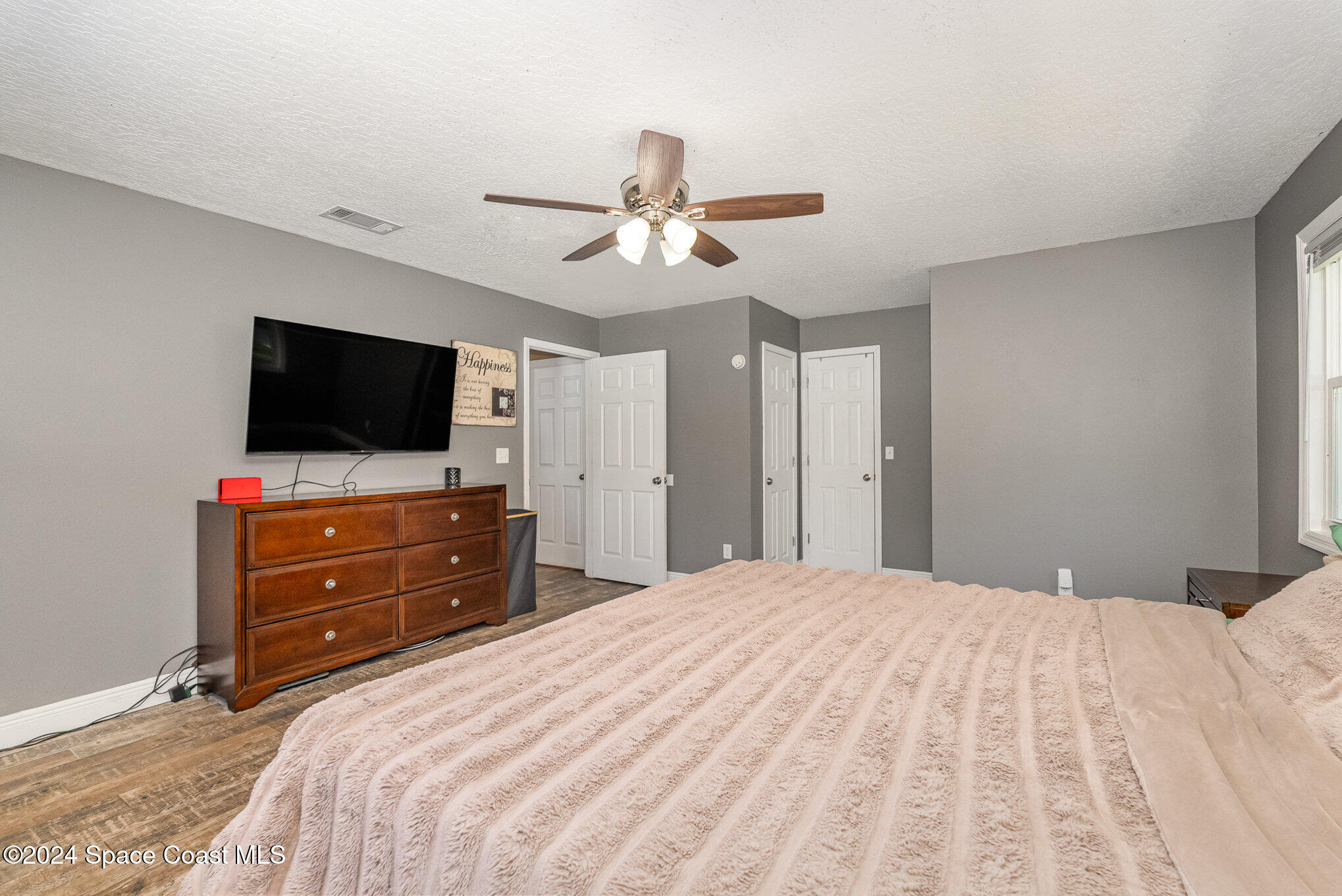 3330 Lionel Road Mims, FL 32754 - Photo 23 of 35 a bedroom with a bed and a flat screen tv