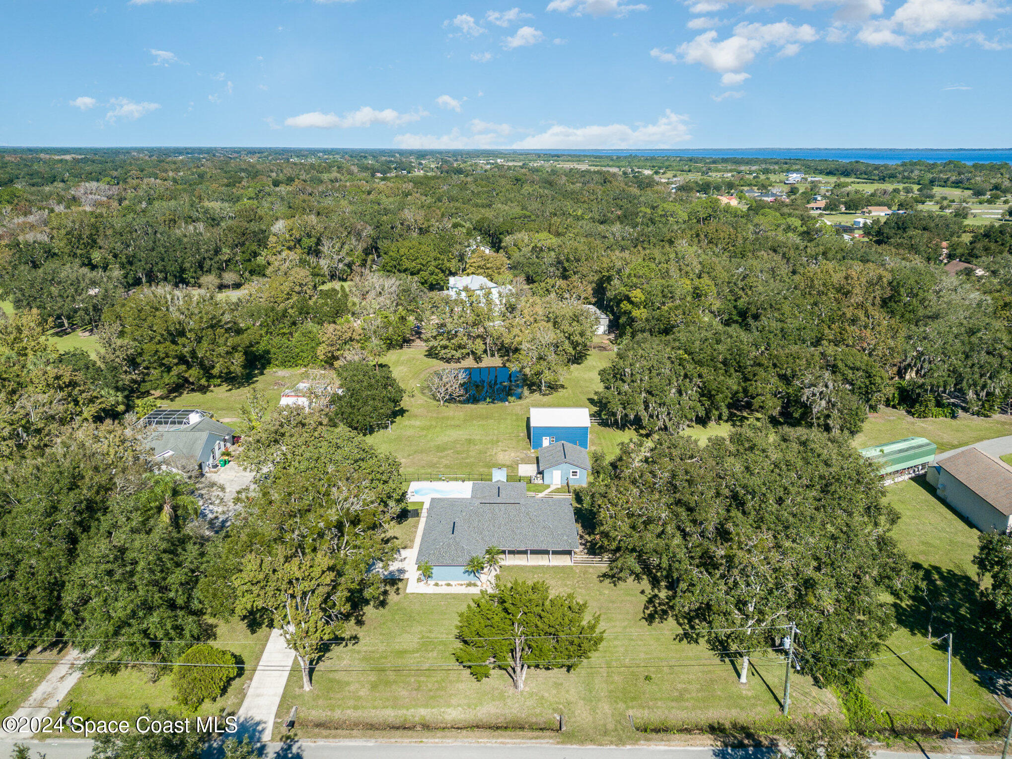3330 Lionel Road Mims, FL 32754 - Photo 34 of 35 an aerial view of residential houses with outdoor space and trees