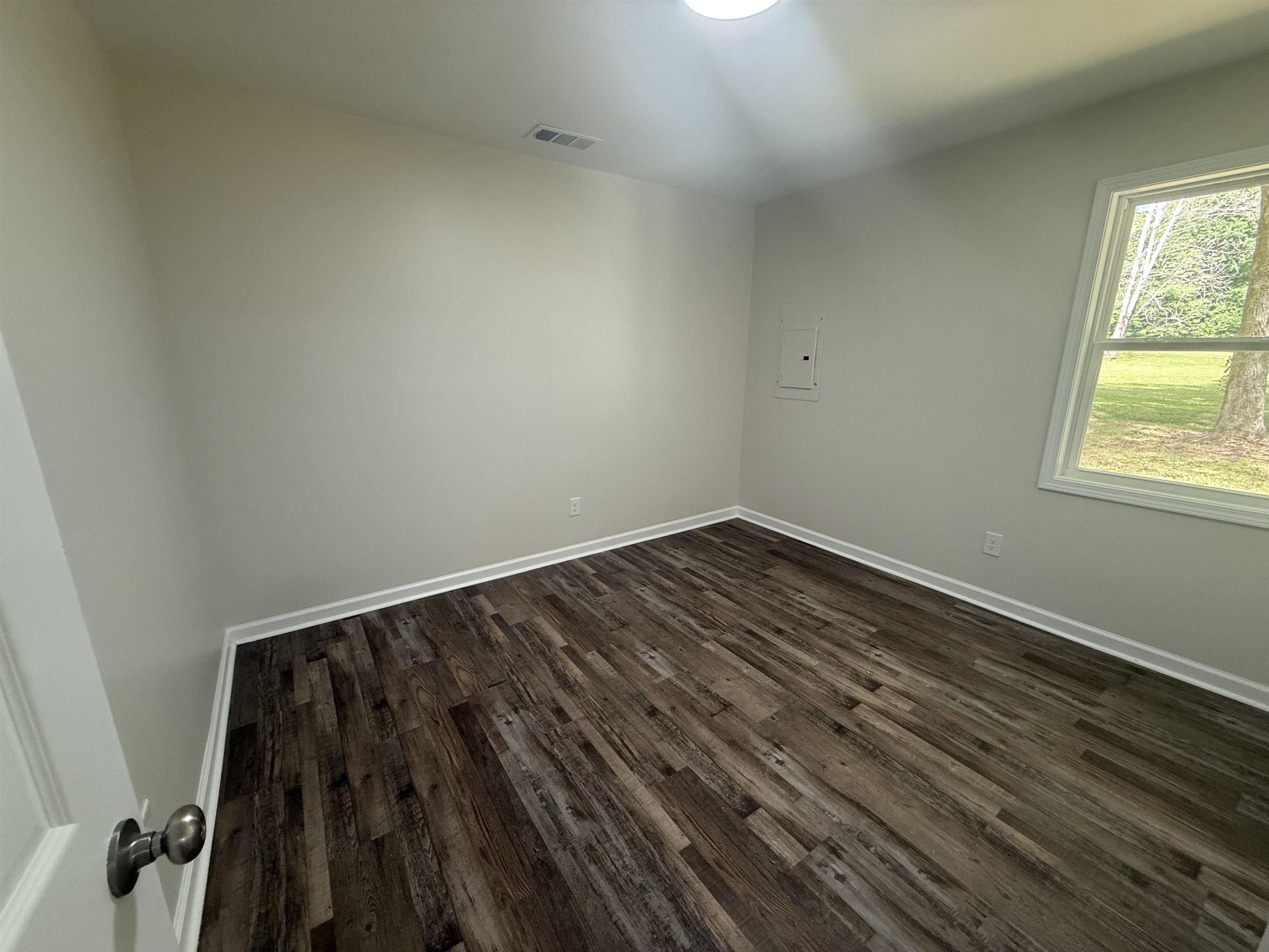 195 Poole Road Moscow, TN 38057 - Photo 12 of 21 Room featuring wood-finish flooring, white baseboards, and neutral wall tones