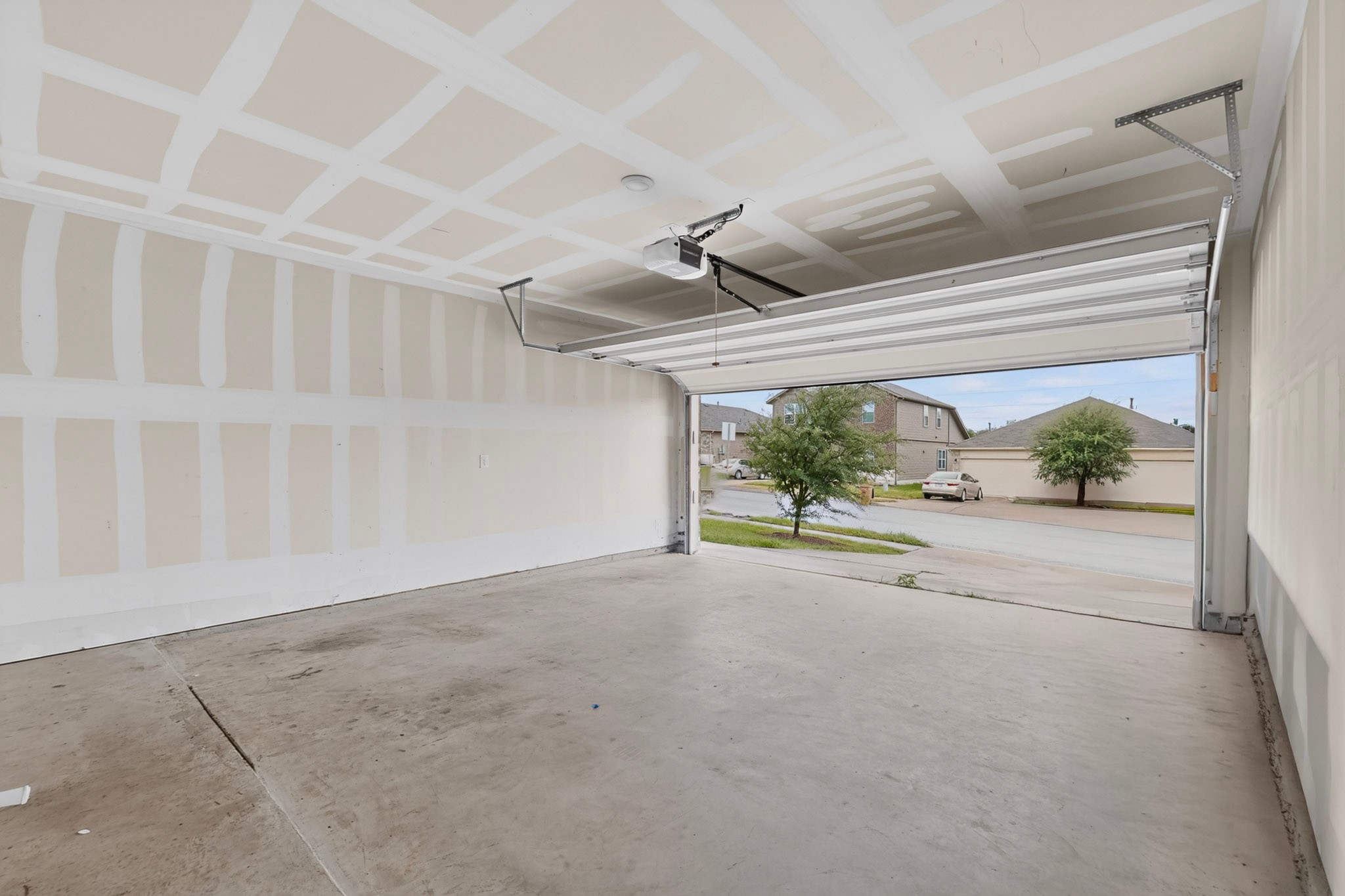 6920 Ranchito Drive Austin, TX 78744 - Photo 4 of 4 A spacious, clean garage with an automatic door opener awaits vehicles and storage.