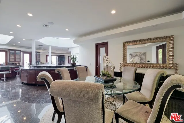a living room with furniture and a large mirror