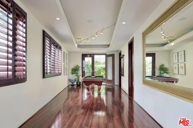 a view of a large room with wooden floor and furniture