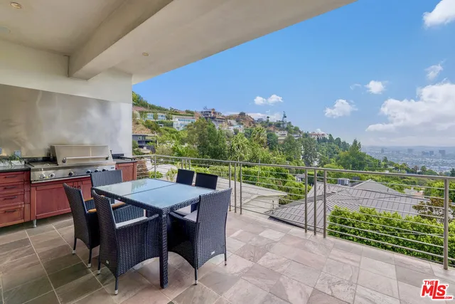 a view of a patio with a table and chairs