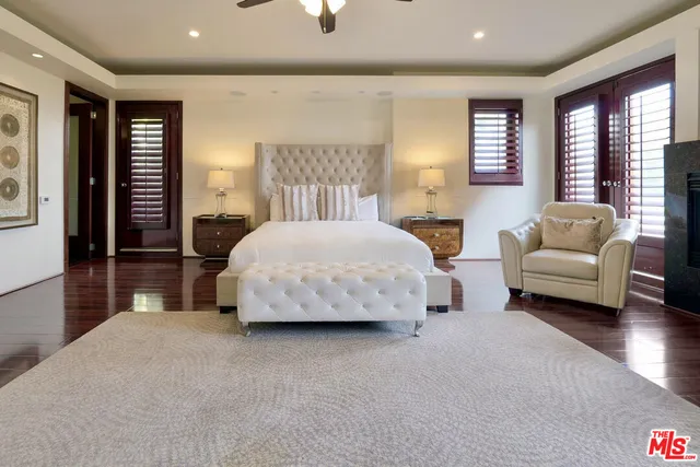 a spacious bedroom with a bed and a couch