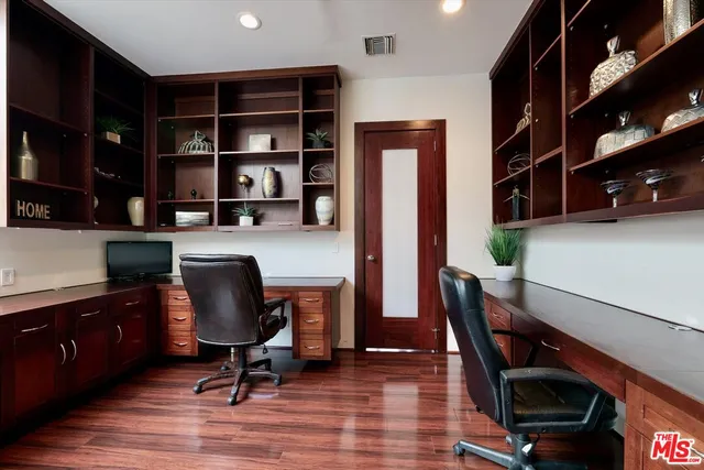 a view of a workspace with furniture and wooden floor