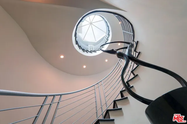 a view of staircase with a large window and a mirror