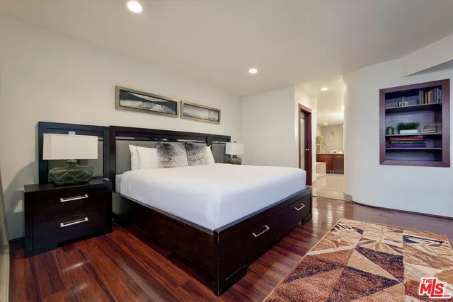 a bedroom with a bed and a night stand