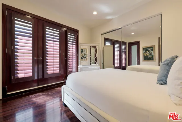 a spacious bedroom with a large bed and a large window