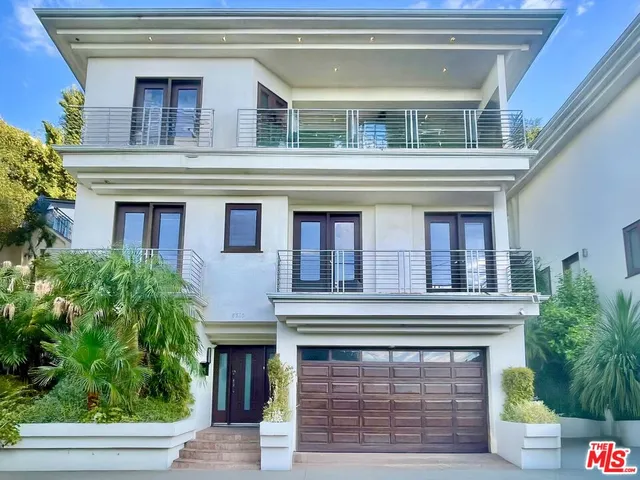 a building with potted plants in front of it