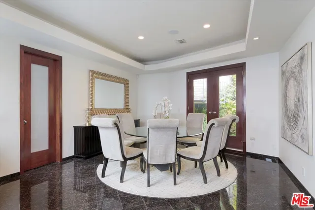 a dining room with furniture and wooden floor