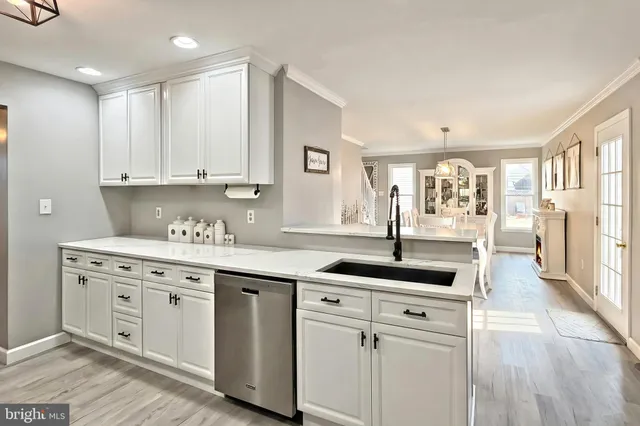 a kitchen with stainless steel appliances granite countertop a sink and cabinets