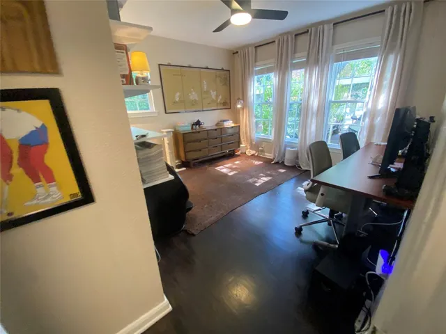 a view of a hallway and a livingroom with furniture