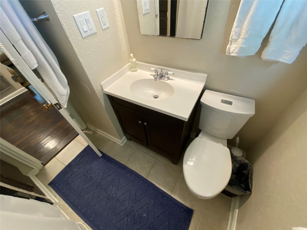 1404 West 12th Street, Unit C Austin, TX 78703 - Photo 15 of 34 a bathroom with a toilet sink and mirror