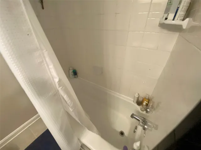 a view of a hallway with wooden floor and stairs