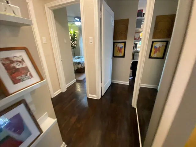 a view of a hallway and a livingroom with furniture